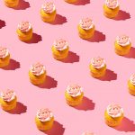 Still life photo of cupcakes on pink background