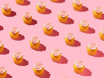 Still life photo of cupcakes on pink background